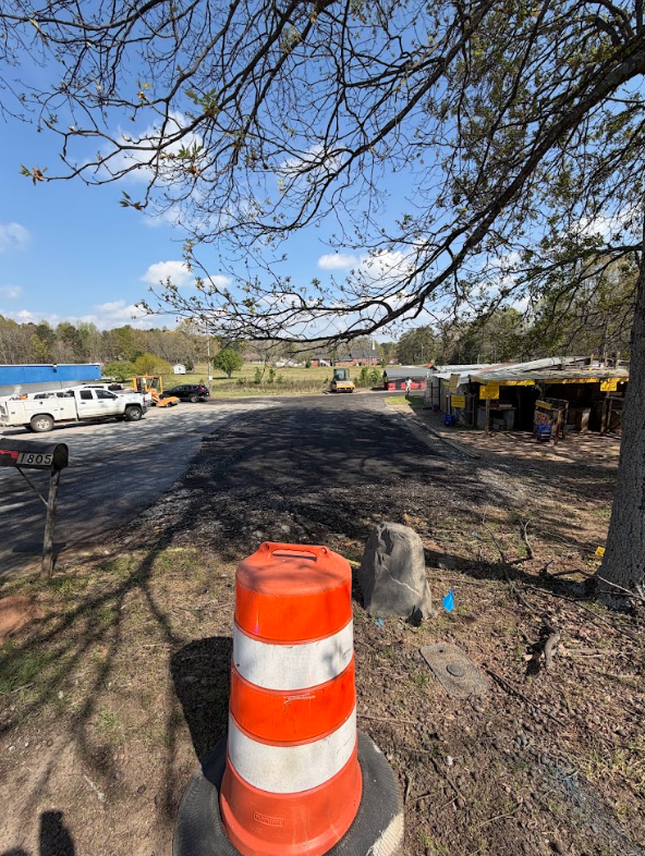 Freshly graded driveway entrance and roadway approach on a rural property