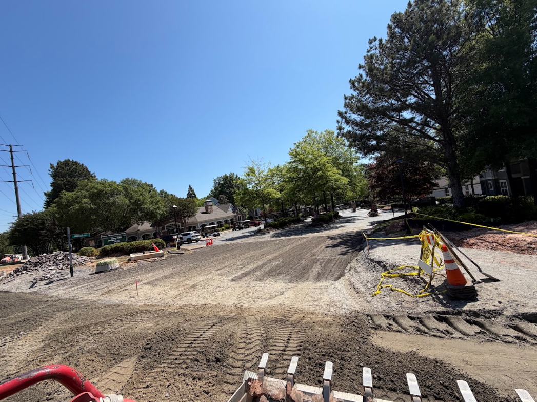Regraded gravel drive lane shaped and leveled from behind the loader bucket