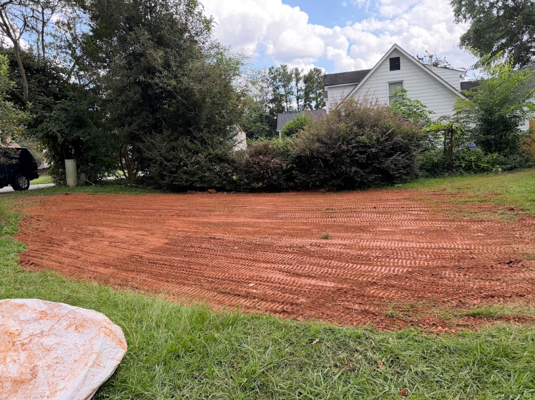 Front yard area leveled down to red clay and shaped flat, ready for sod or seed